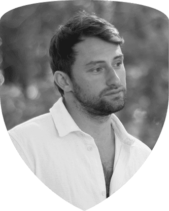 Daneel Minev, framed by the Guild crest shield